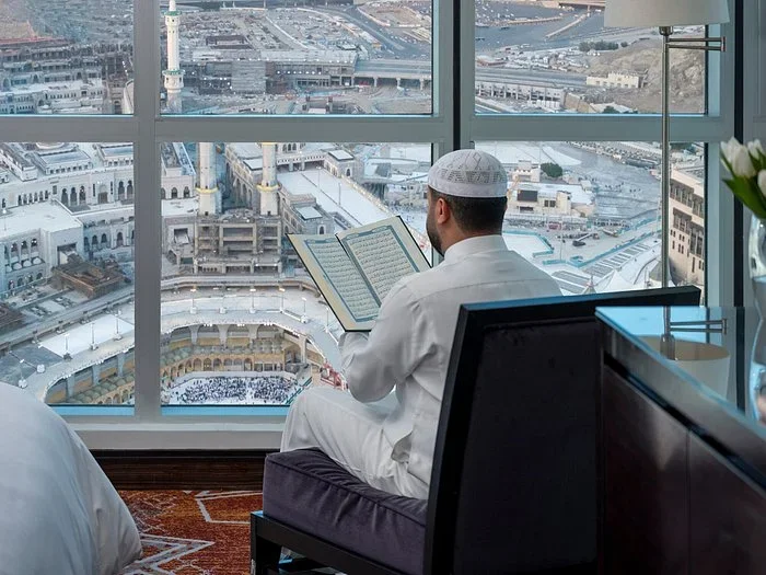 Pilgrim offering prayer facing Kaaba view from hotel during best Umrah packages 2026 UK